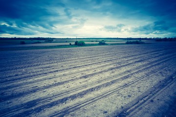 Vintage photo of plowed field in calm countryside