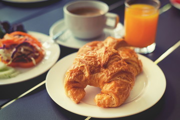 Croissant Breakfast served with black coffee and breakfast menu.