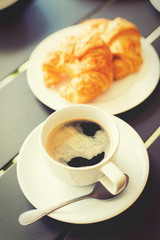 Croissant Breakfast served with black coffee and breakfast menu.