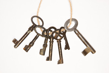 A lot vintage keys from the locks on a white background