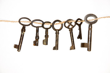 A lot vintage keys from the locks on a white background