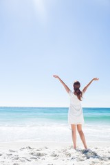 Pretty brunette standing arms outstretched 