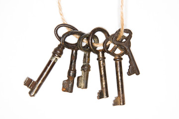 A lot vintage keys from the locks on a white background