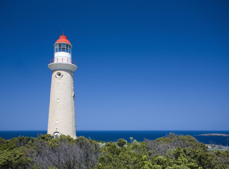 Fototapeta na wymiar Lighthouse against clear blue sky