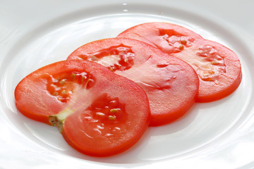 sliced tomato on white plate