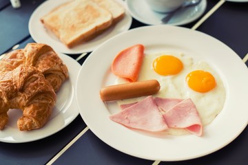 Ham breakfast served with coffee, toast and salads that taste go