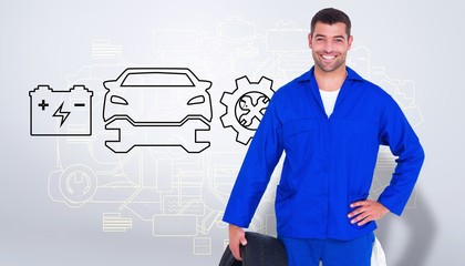 Composite image of smiling male mechanic holding tire - Powered by Adobe