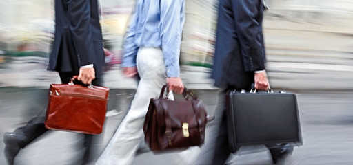 motion blurred business people walking on the street