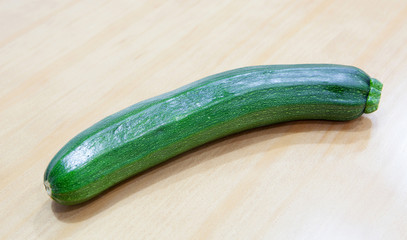 Green zucchini on a wooden surface