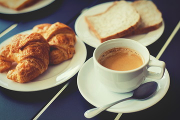 Croissant Breakfast served with black coffee and breakfast menu.