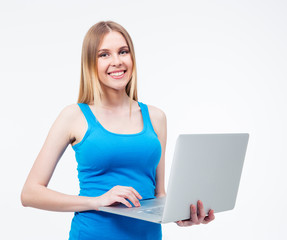 Fototapeta premium Smiling young woman standing with laptop 