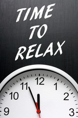 Time To Relax on a blackboard above a modern clock