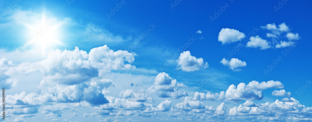 Wall mural white heap clouds and bright sun in the blue sky.
