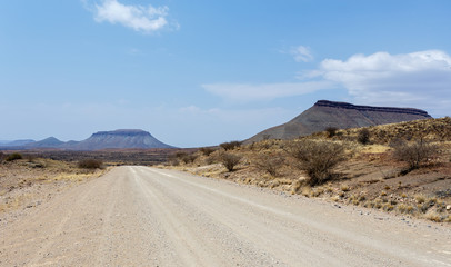 endless road in Namibia moonscape landscape