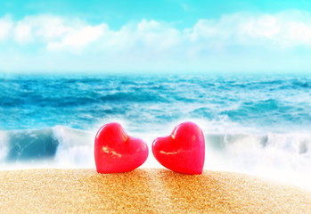 Summer beach. Two hearts on the sand.
