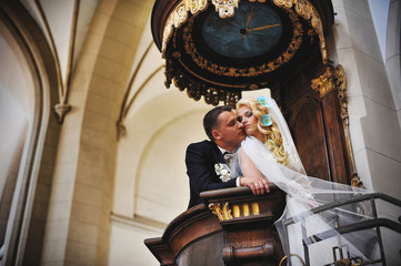 Young beautiful wedding couple at the old catholic church