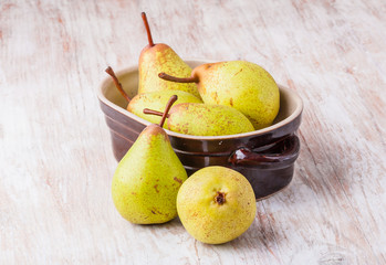 Pears in bowl on a wooden table.