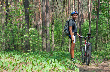 Obraz premium Young man standing in the forest 