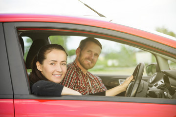 Couple in a red car