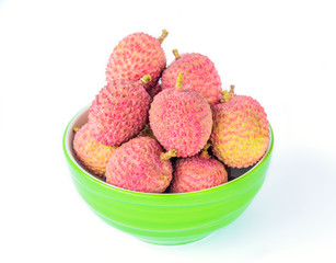 Ripe lychee fruit in green bowl against white background