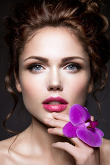 Beautiful girl with violet flower.