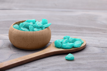 Spa concept. Blue salt and spoon on wooden background.