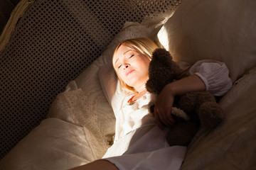 Woman lying in bed in sunlight