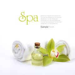 Spa concept. Green orchid, oil and white towels.