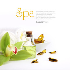 Spa concept. Green orchid, oil, yellow potpourri and towels.