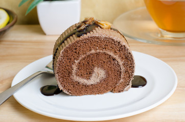 Chocolate roll cake with caramel and chocolate sauce