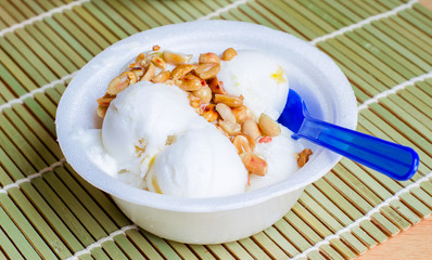 Coconut ice cream homemade with roasted peanuts