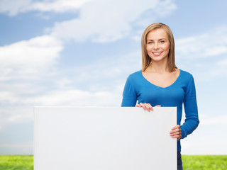 smiling young woman with blank white board