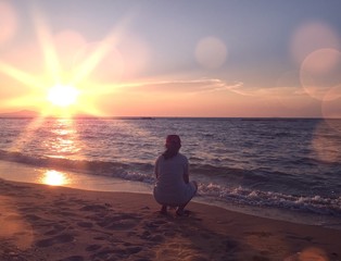 girl sitting on the beach. 