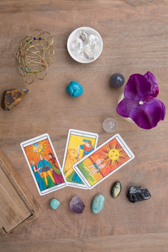 Tarot cards and stones under wooden background