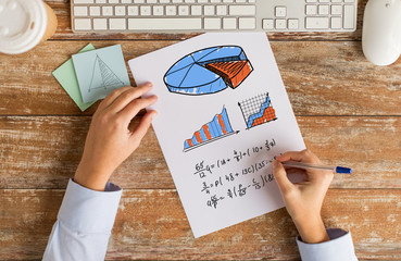 close up of hands solving task or writing equation