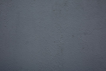The bright grey rough grainy plaster background