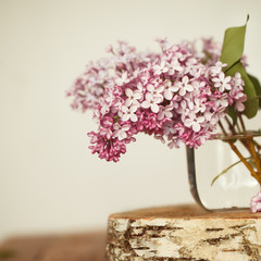 Bouquet of lilac spring flowers on wooden background.