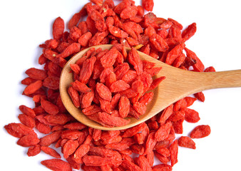 dry red goji berries  in the spoon on white background