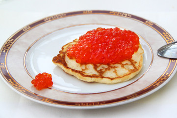 Pancake with red caviar