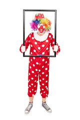 Male clown holding a big picture frame