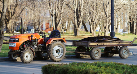Orange tractor with a trailer park