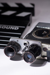 Old movie camera with film clapperboard