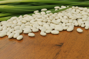 onions and beans on wooden background