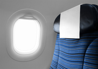 Blue seat beside blank window plane
