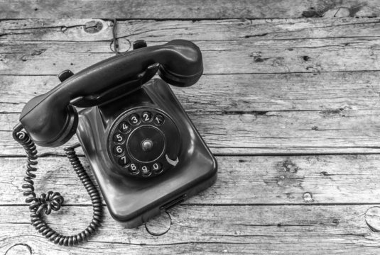 Old telephone on wooden background