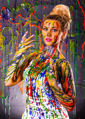 Beautiful woman covered with multicolored paints