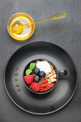 Berries, yogurt, honey and homemade granola for breakfast.