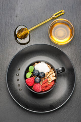 Berries, yogurt, honey and homemade granola for breakfast.