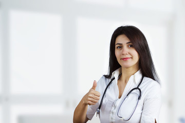 Smiling Female doctor holding thumb up 