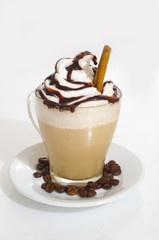 Iced coffee with foam, cinnamon and coffee beans
